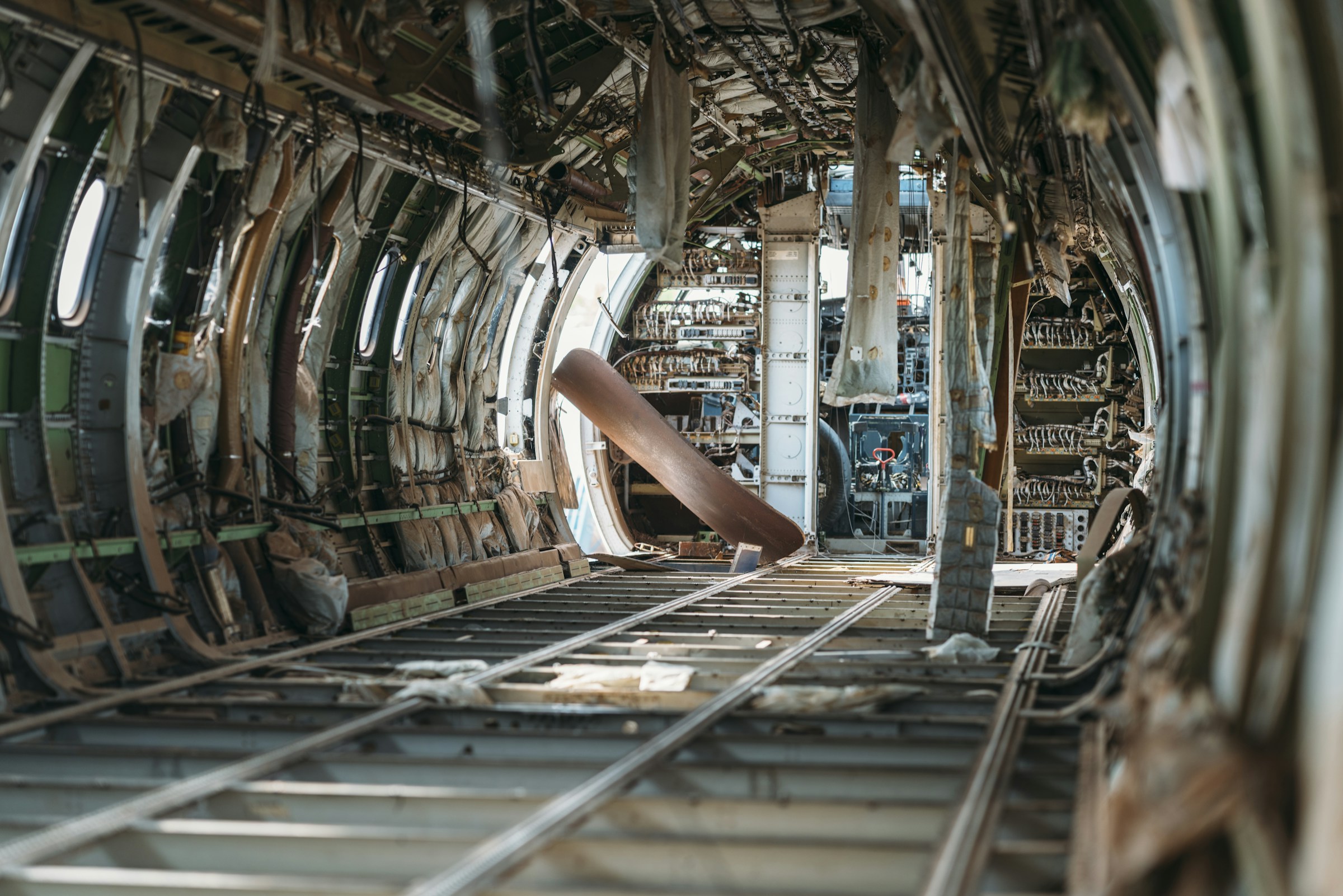 Gutted aircraft fuselage interior with the cabin lining stripped away and structural ribs exposed